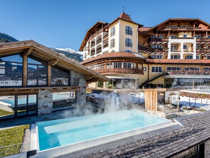 Luxusurlaub - Saunalandschaft: Außensauna - Grän - Hotelansicht im Winter - Hotel Post Lermoos