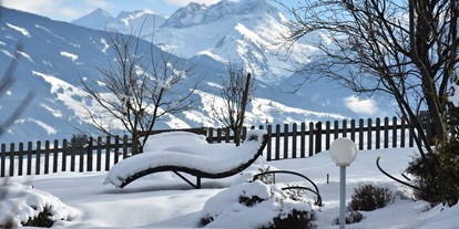 Luxusurlaub - Saunalandschaft: Dampfbad - Going am Wilden Kaiser - Garten im Winter - Gardenhotel Crystal