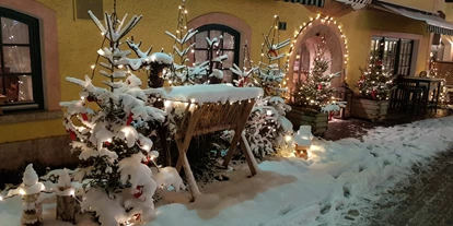 Luxusurlaub - Hotel-Schwerpunkt: Luxus & Familie - Eingang Restaurant Winter - Hotel „Der Kirchenwirt****s"